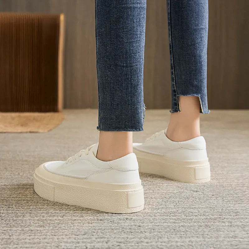 Women's black platform sports shoes with embossed cowhide upper and rubber sole, tied design detail