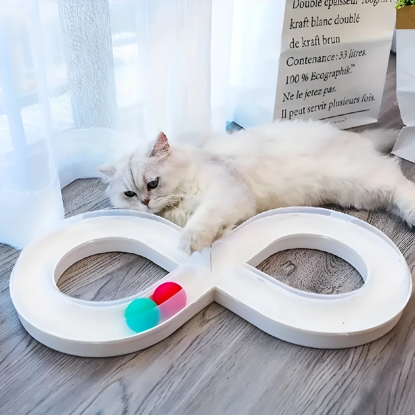 Blue and white cat turntable toy with ball track and teasing stick on wooden floor