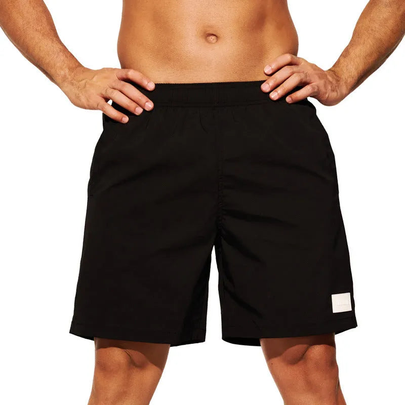 Men's quick-drying nylon sports shorts in green, shown with straight leg and elastic waist.