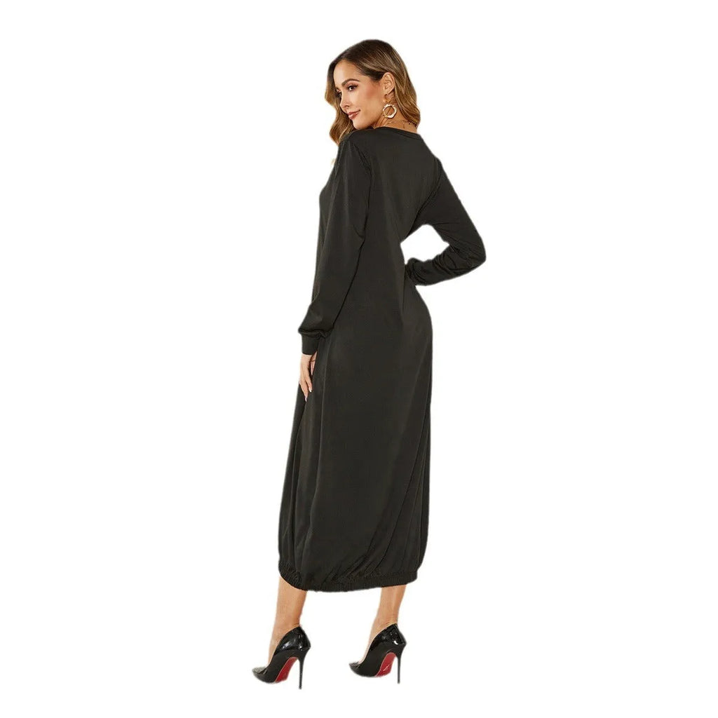 A loose black knitted lantern dress with a lace-up crew neck, showcasing a casual silhouette.
