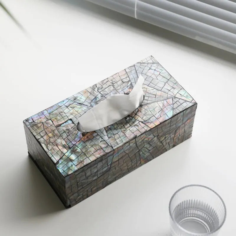 Black rectangular natural shell tissue box storage container with removable insert on a table.