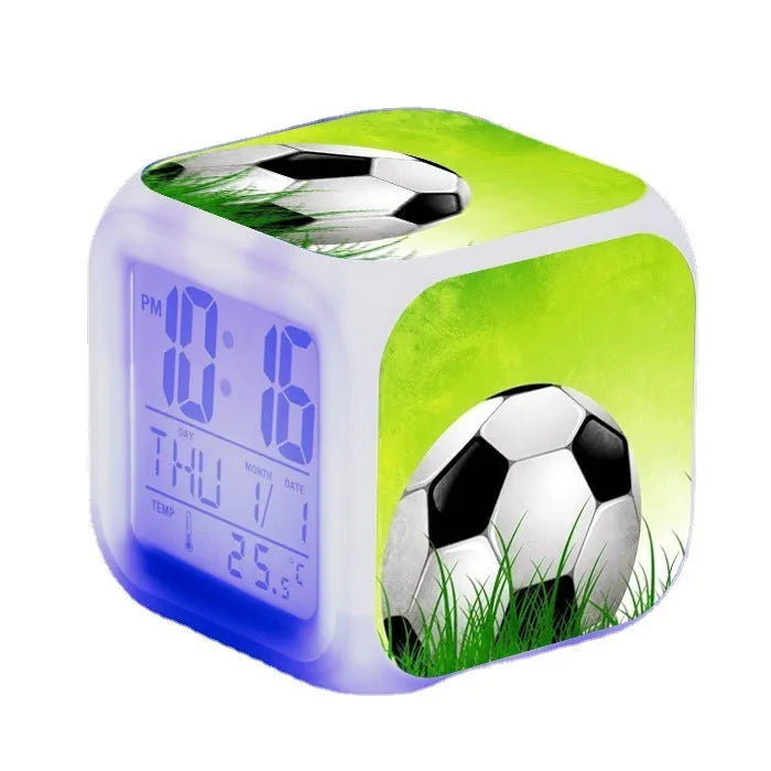 Square plastic alarm clock with a cartoon football pattern, showing silent vibrating alarm models.