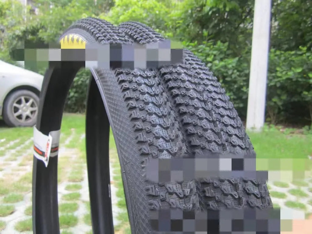 Mountain bike tyre with puncture-proof construction, shown in multiple sizes including 26x1.95 and 27.5x2.1