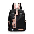Black nylon casual travel backpack with double shoulder straps, external pockets, and a soft handle on a solid background.