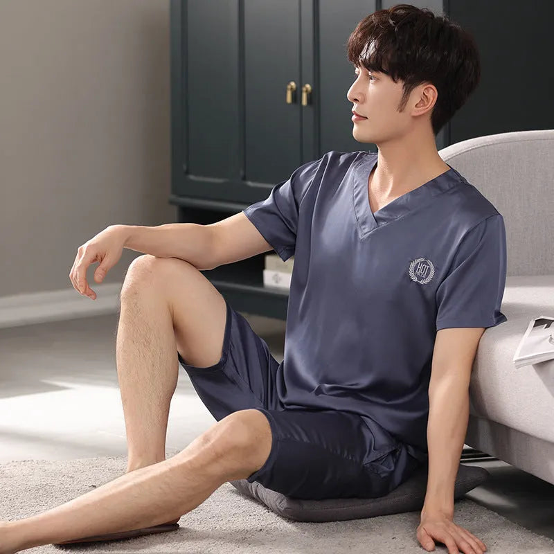 Man wearing a loose grey ice silk short-sleeve pajama shirt and matching shorts.