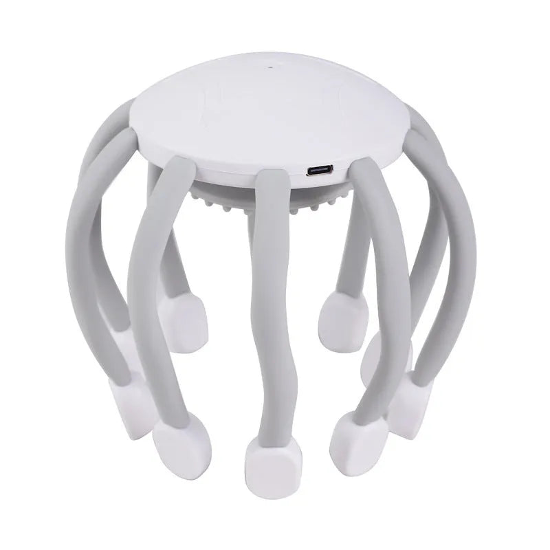 Black USB-powered head massager with multiple claws placed on a scalp
