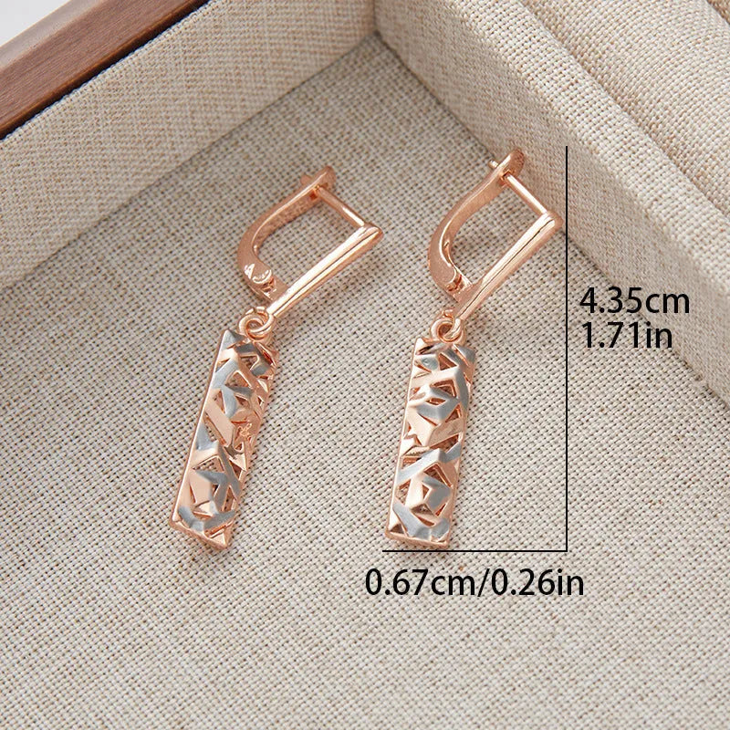 A pair of rectangular hollow geometric stud earrings with a two-tone colour finish on alloy posts.