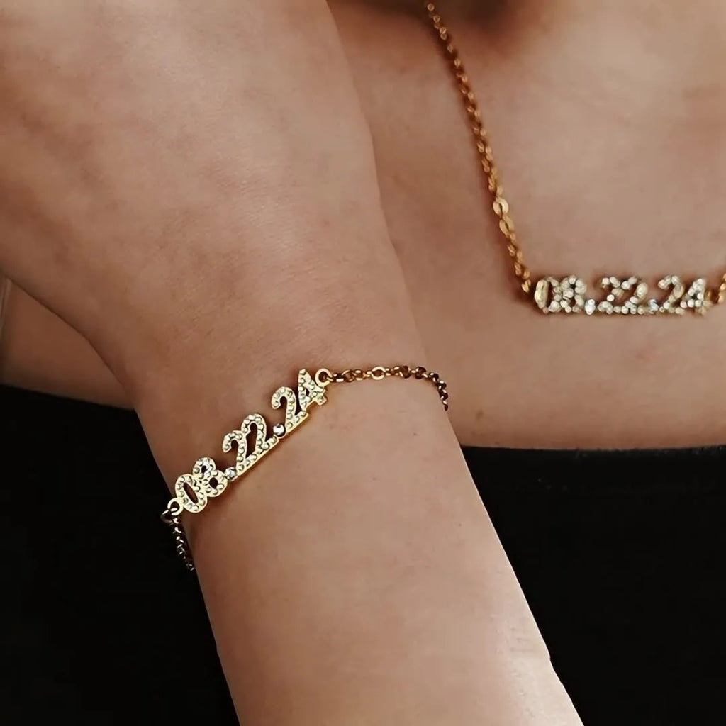 Stainless steel digital bracelet with diamond studded numbers in gold finish.