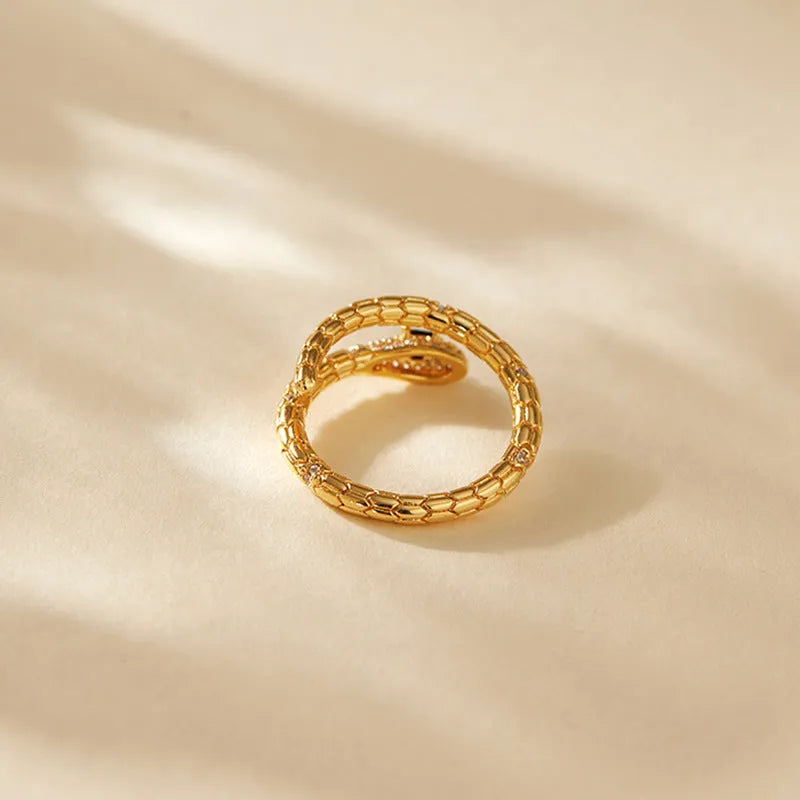 Adjustable copper snake ring with 18K gold plating on index finger