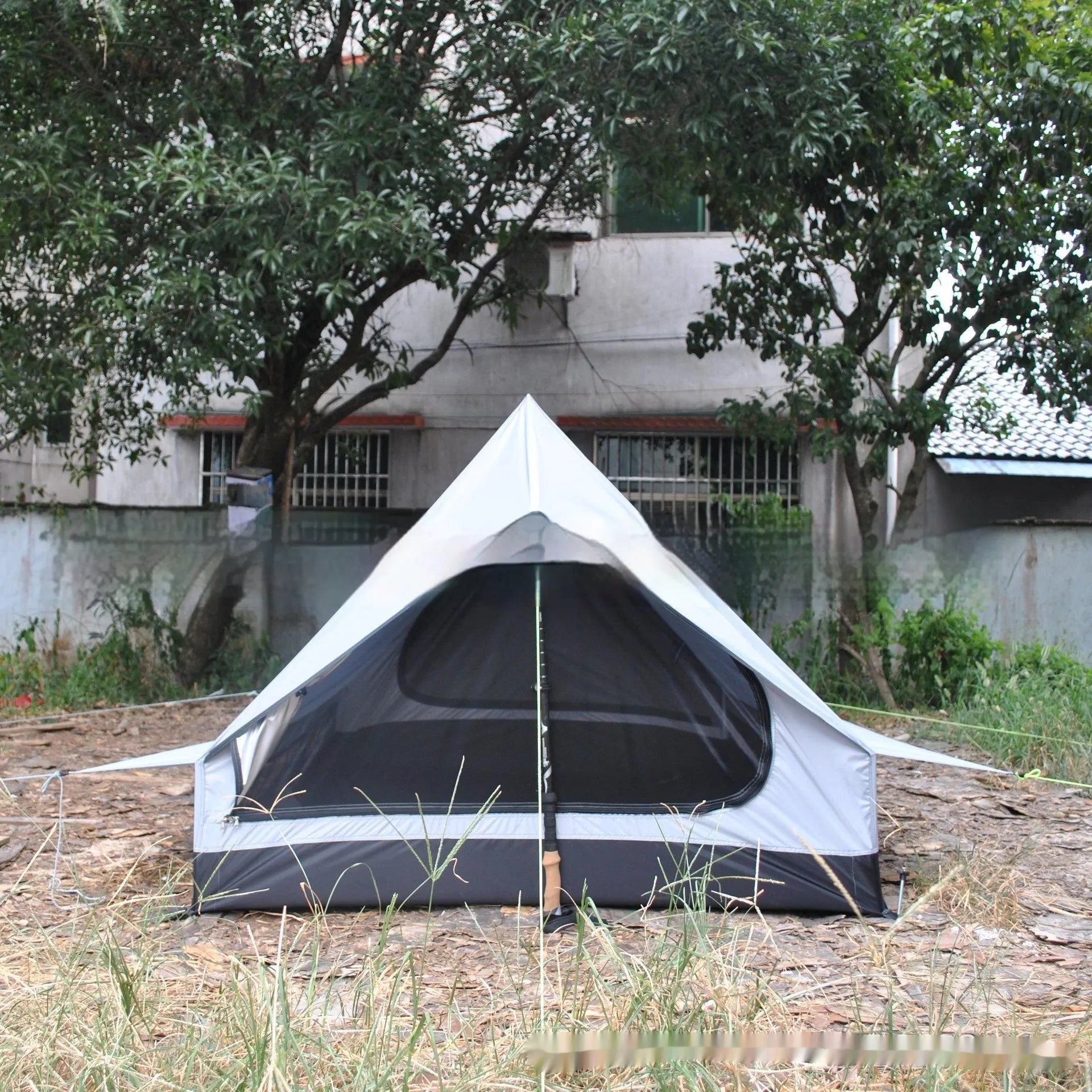 Brown or white A-line cabin tent using hiking canes for support with dimensions 210x150x110cm