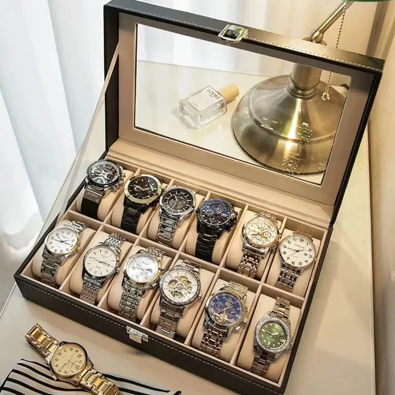 Grey leather watch storage box with clear lid showing watch compartments