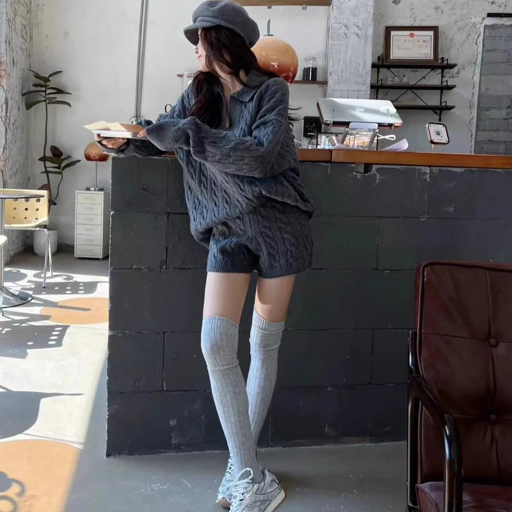 Women's creamy-white cable knit suit set with long sleeve jumper and elastic waist shorts.