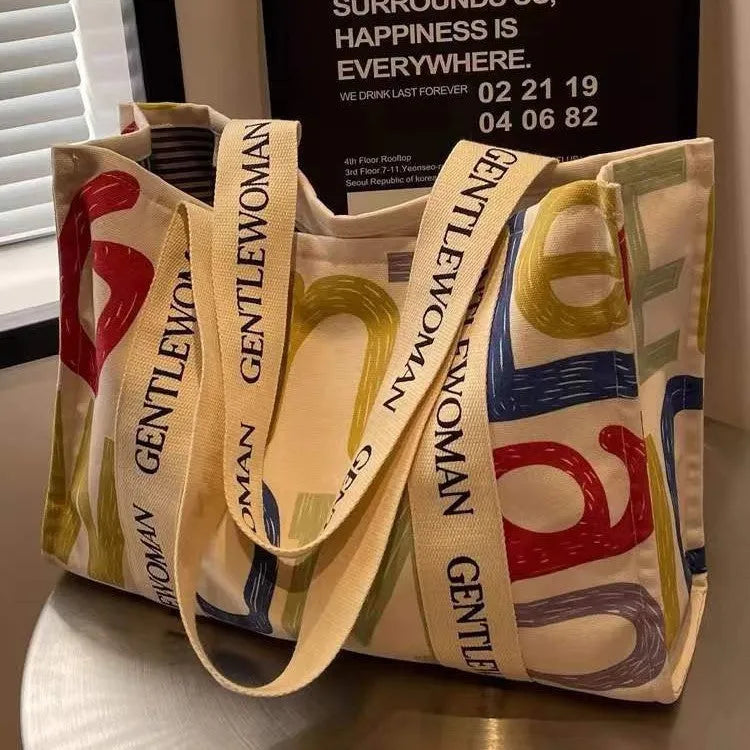 Women's large canvas tote bag with printed design options for travel and shopping.