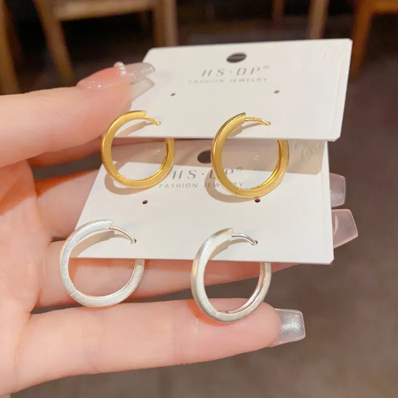 Circular geometric copper ear clips for women with gold or silver finish