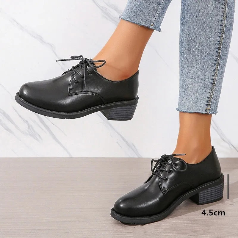 Black women's chunky heel ankle boots with rubber sole and professional styling