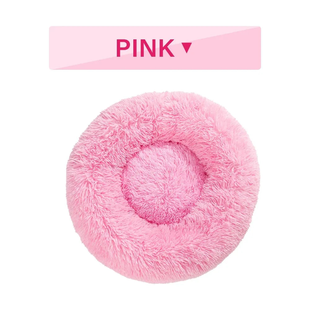 Fluffy donut-shaped pet bed in long plush fabric, shown in a light grey colour.