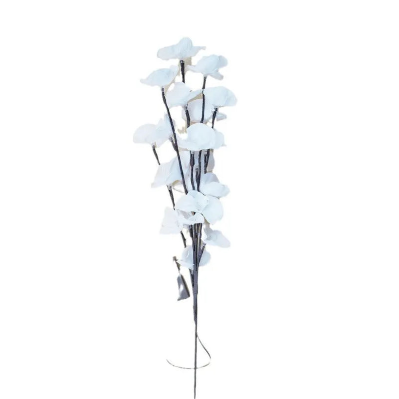 Pink LED phalaenopsis orchid branch decorative light, 65 cm tall, on a table.