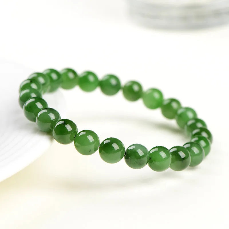 Polished natural Jasper Hetian jade bead bracelet on wrist, showing bead detail.