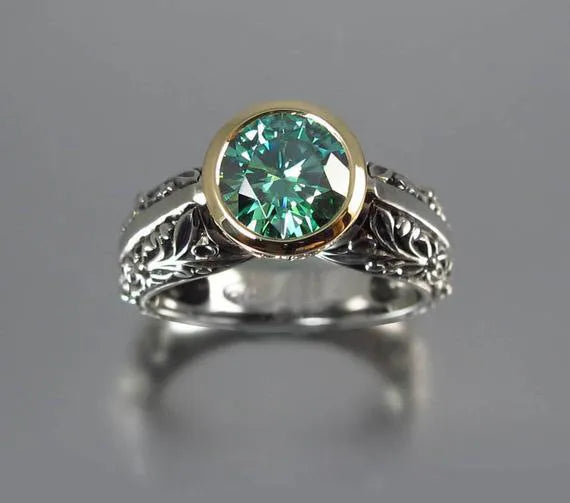 Gold-plated flower-shaped vintage ring with a green gemstone on a model's finger