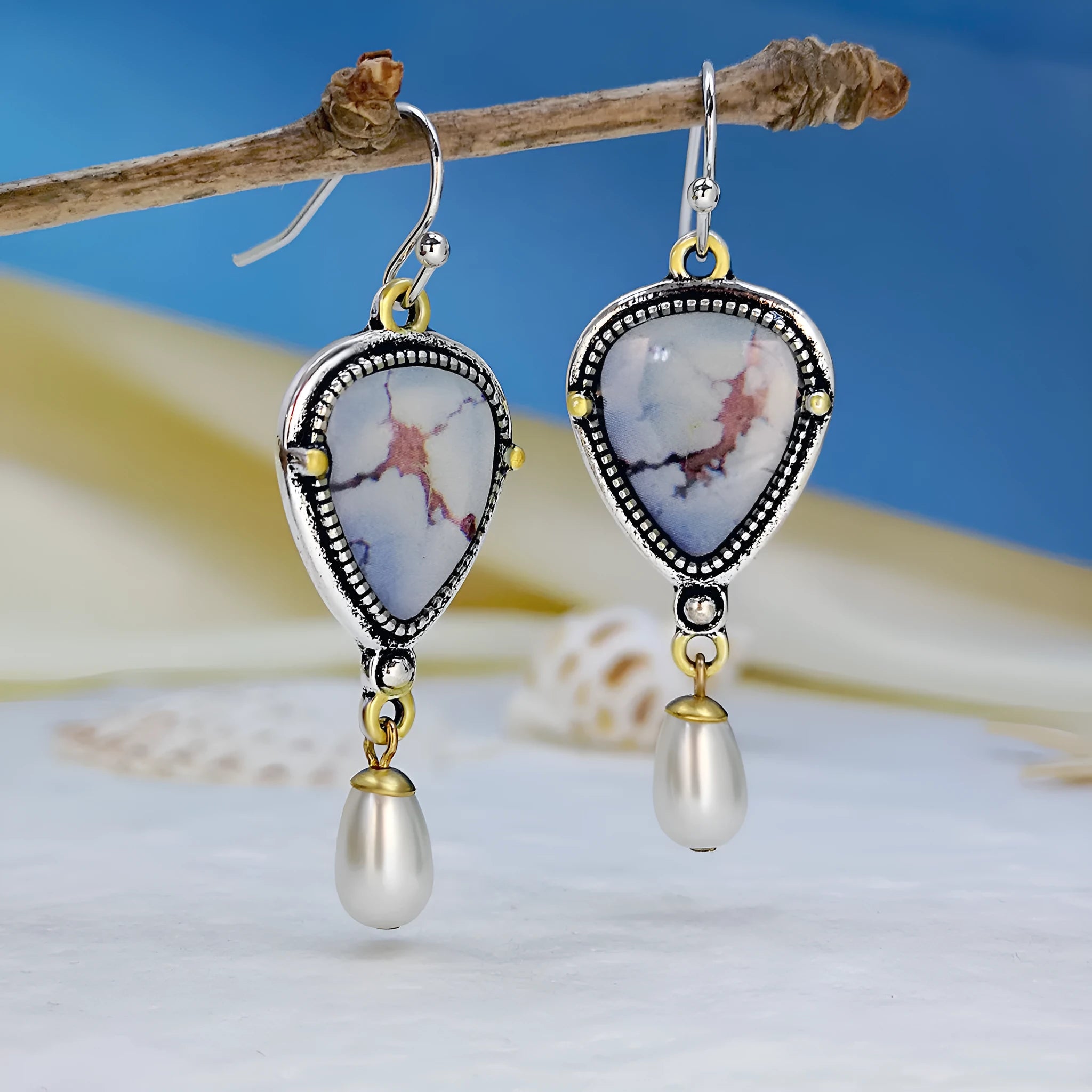Retro blue drop earrings with electroplated metal, synthetic blue opal, and white pearl geometric design