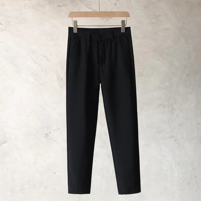 Boys slim straight tapered wool trousers in light grey on a hanger, showing the straight leg opening and business casual style.