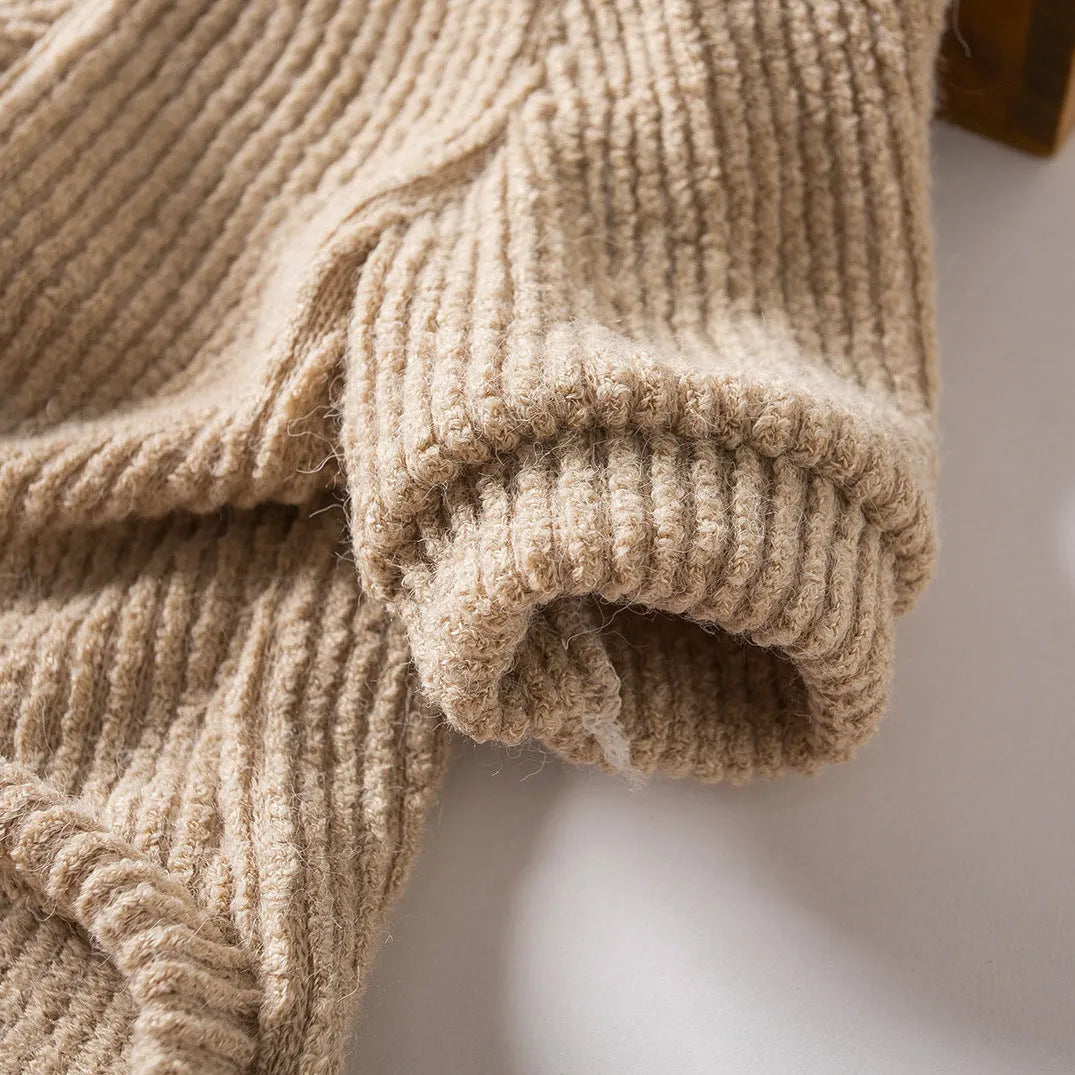 Brown cloth pullover dog sweater on a small breed dog.