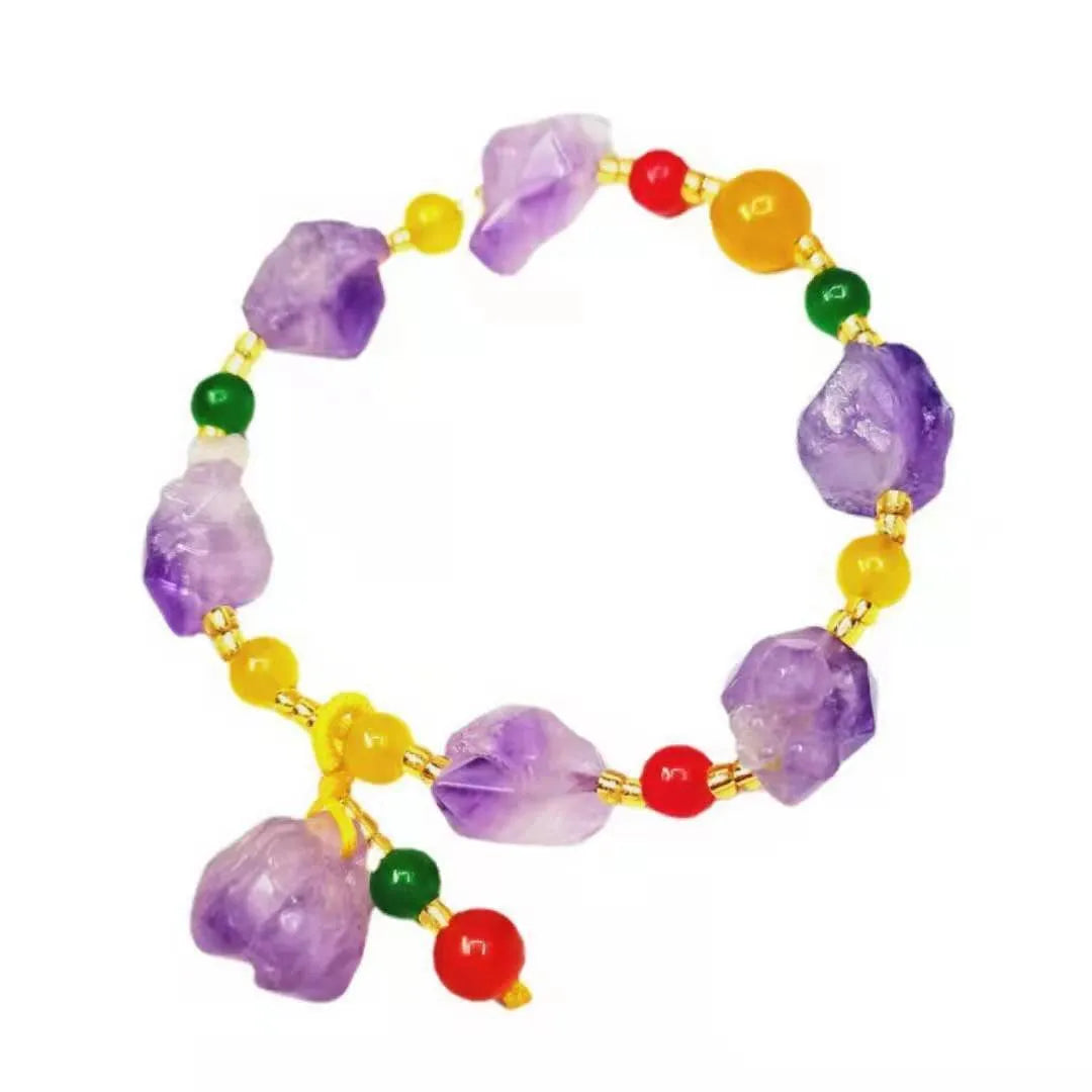 Close-up of a purple natural amethyst bead bracelet with a fu charm for women, on a white background.