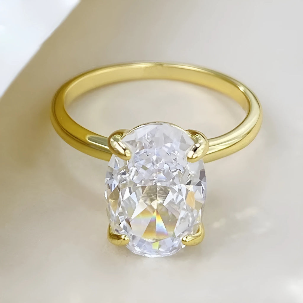 Oval gemstone ring in four-claw setting with 6x9mm stone on finger