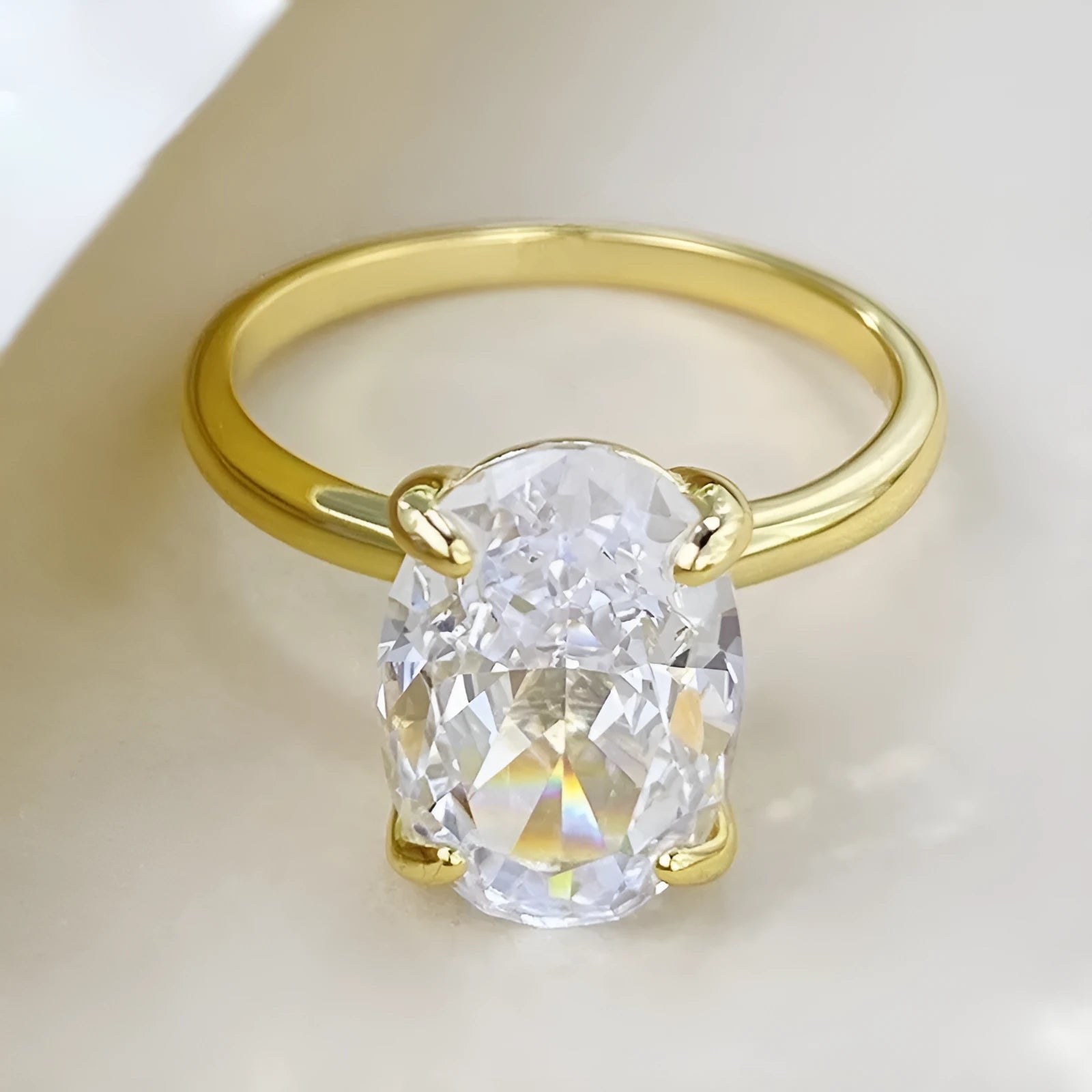 Oval gemstone ring in four-claw setting with 6x9mm stone on finger