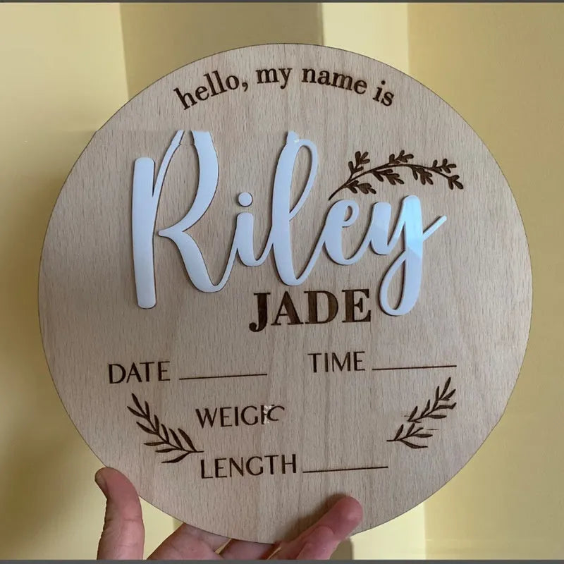 Square 15cm wooden baby name plaque with birth details displayed, shown in three style options.