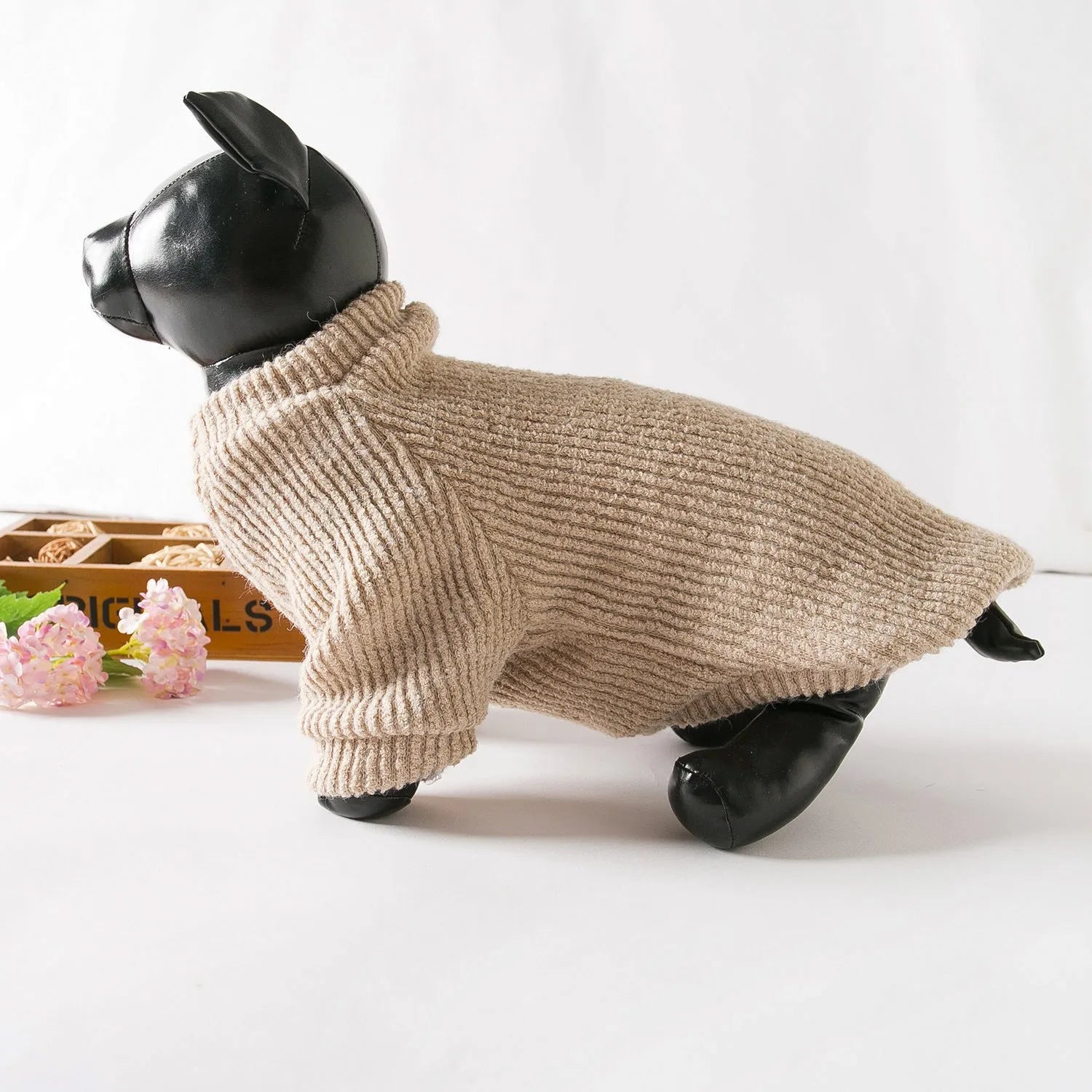 Brown cloth pullover dog sweater on a small breed dog.
