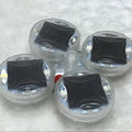 Colourful solar-powered LED valve light for mounting on vehicle wheel hubs.