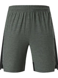 Men's casual spandex shorts in forest green showing stretch fabric and mid-waist design