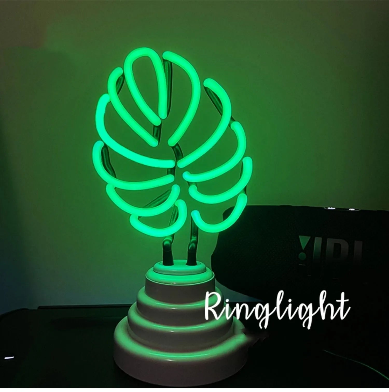 Creative minimalist bamboo-shaped desk lamp with green light on a white background.