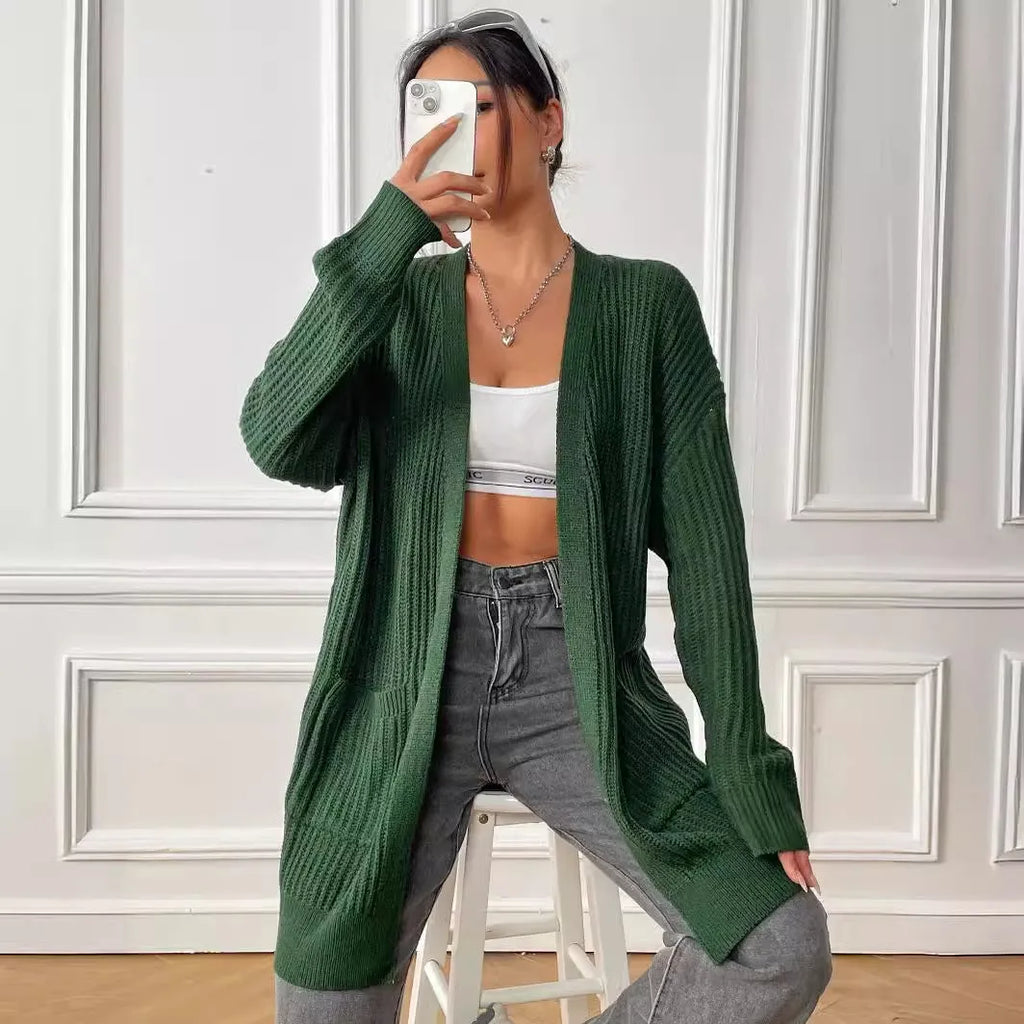 Women's dark green two-pocket acrylic cardigan sweater with loose fit and long sleeves