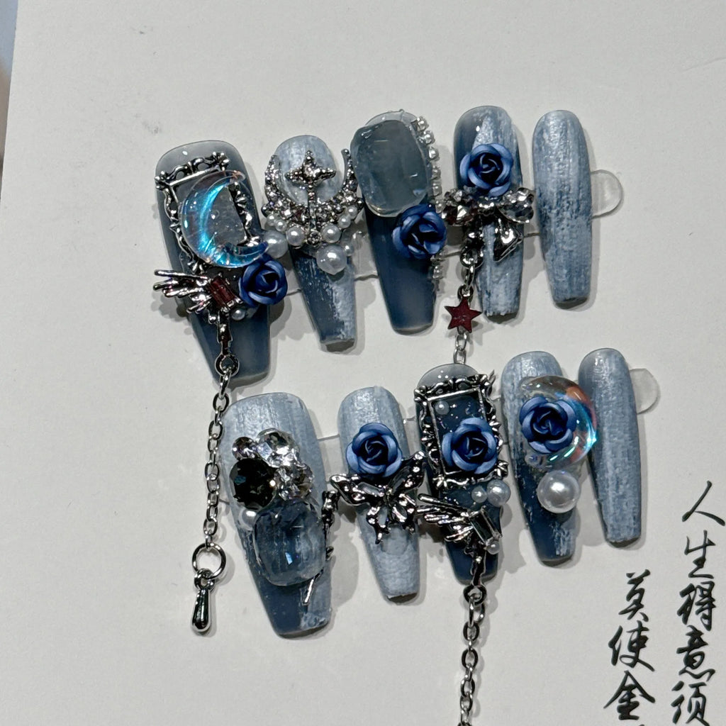 Women's ornate rose floral pattern manicure nails in heavy industry blue colour on a plastic armour suit.