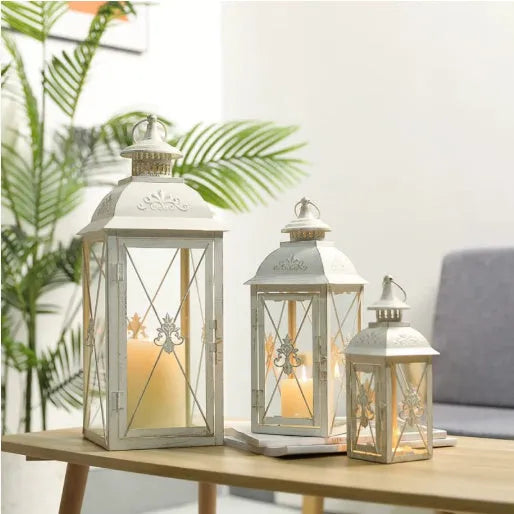 Black wrought iron floor-standing storm lantern with tempered glass panels for outdoor candle lighting