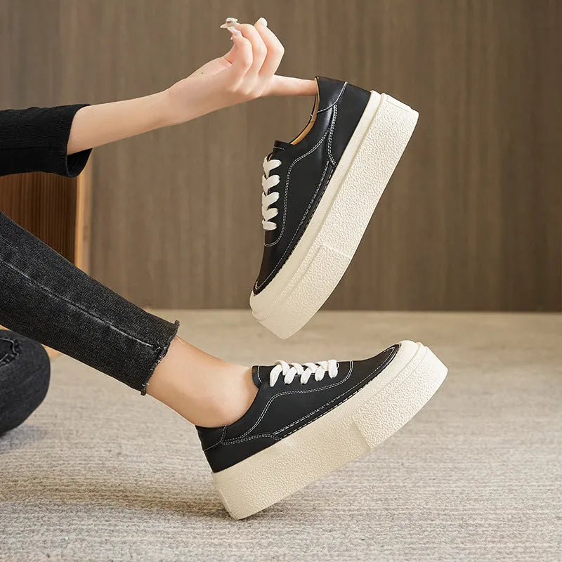 Women's black platform sports shoes with embossed cowhide upper and rubber sole, tied design detail
