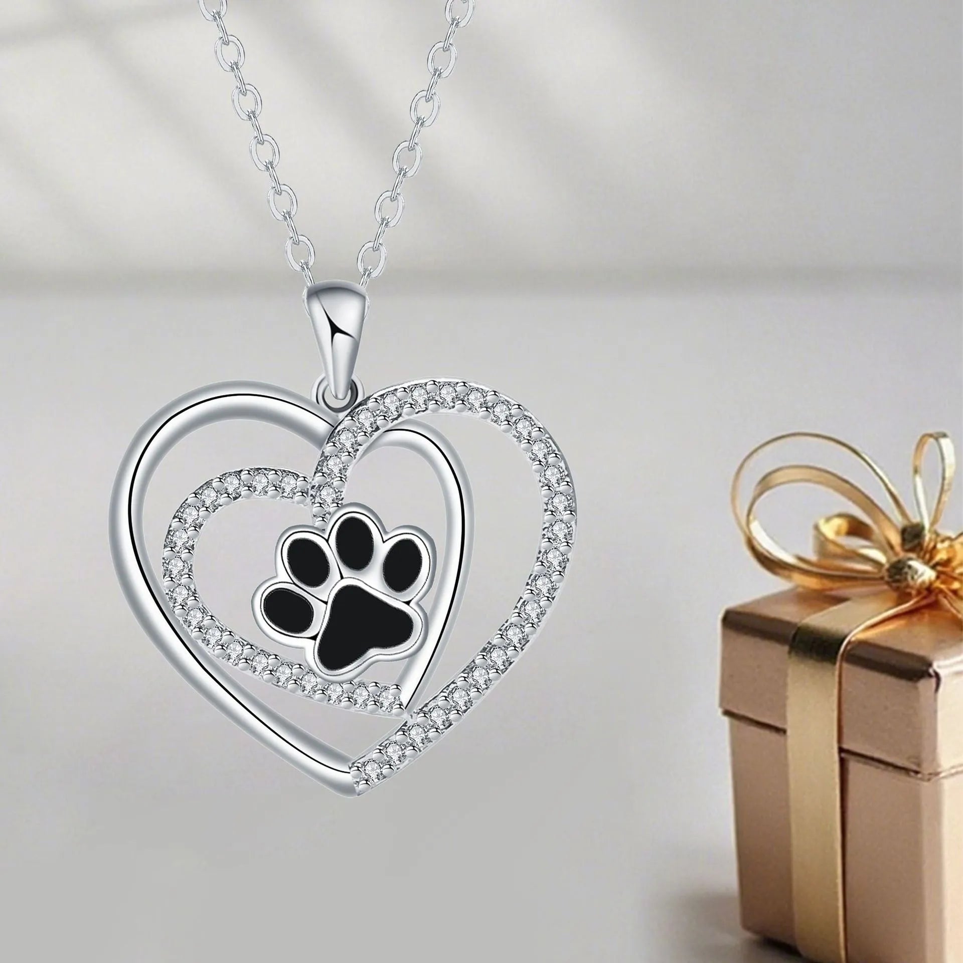 Women's copper necklace with dog paw print pendant and heart charm on cross chain
