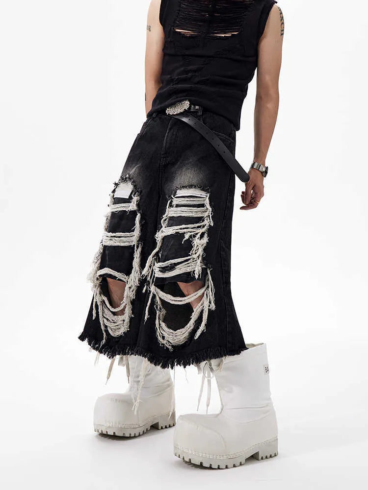 Black wide-leg cropped jeans with ripped patch detail on the legs, showing a mid-high waist and loose fit.
