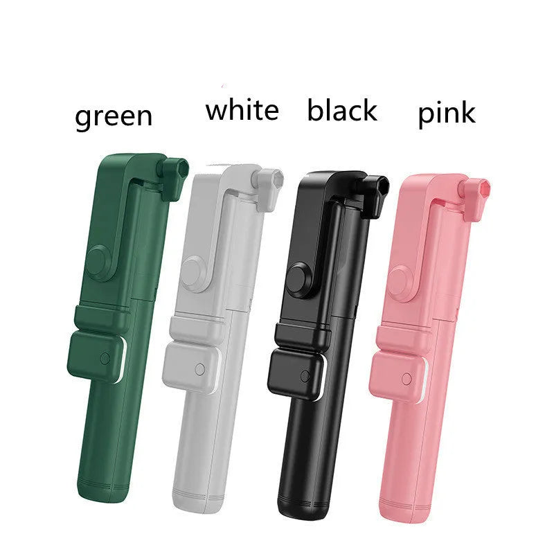 Black Bluetooth selfie stick tripod with phone holder, fill light, and remote control on a table.