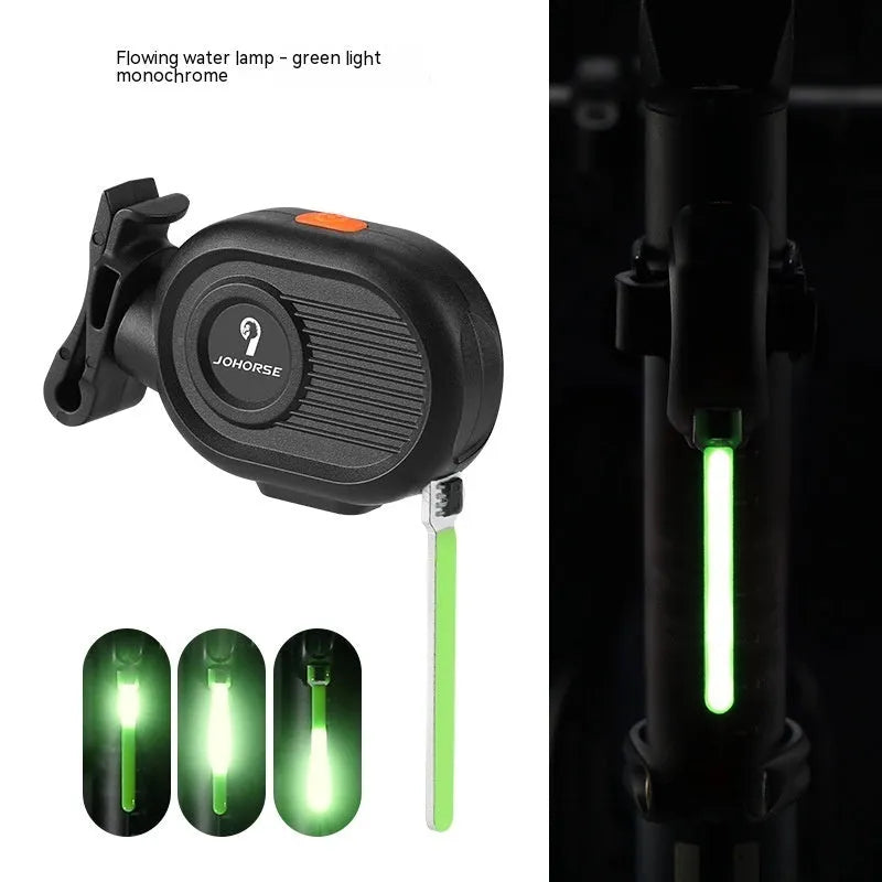 Bicycle rear safety taillight displaying a colourful running water or waterfall light effect on a black background.
