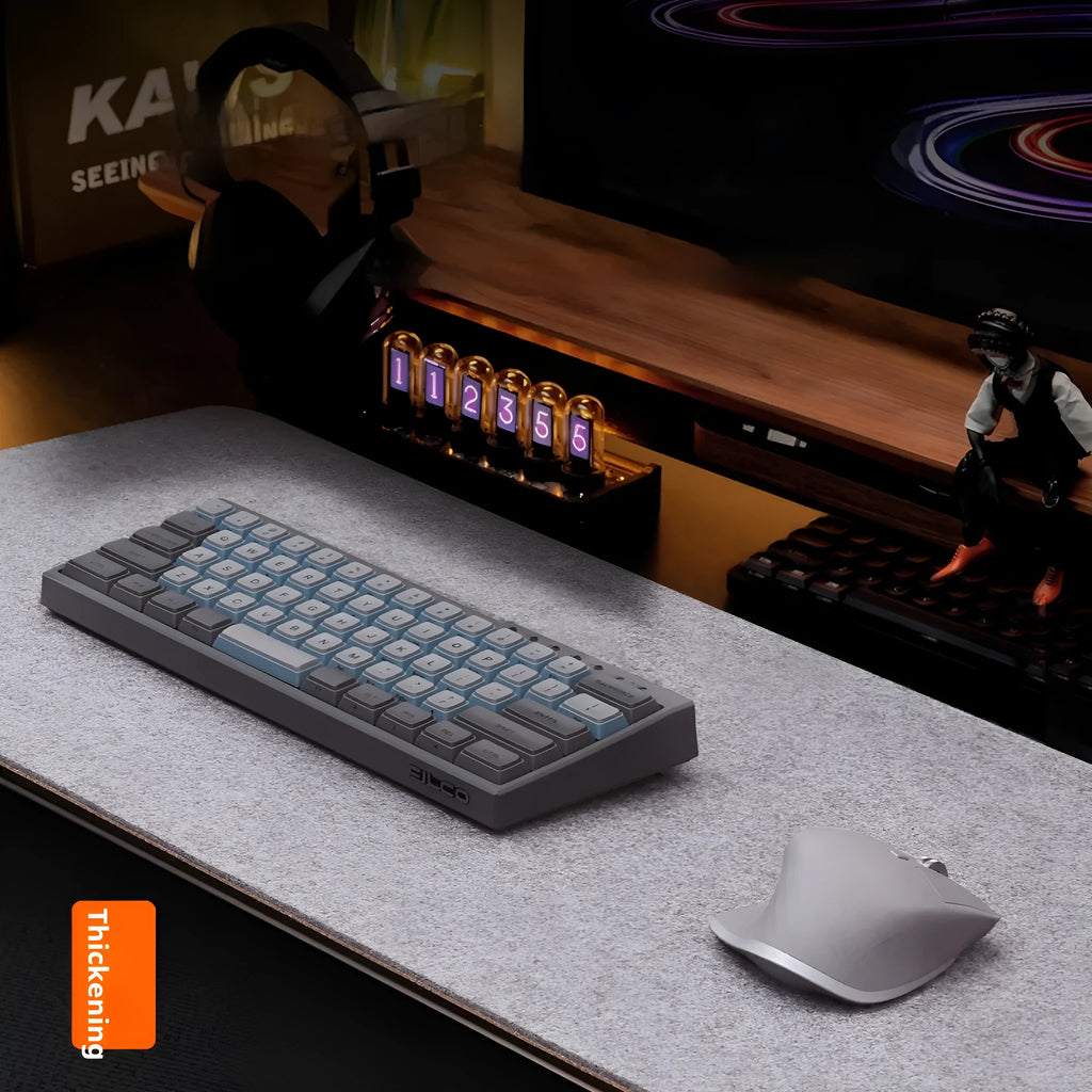 Oversized grey felt and cork desk mouse mat shown on a wooden desk with keyboard and mouse.