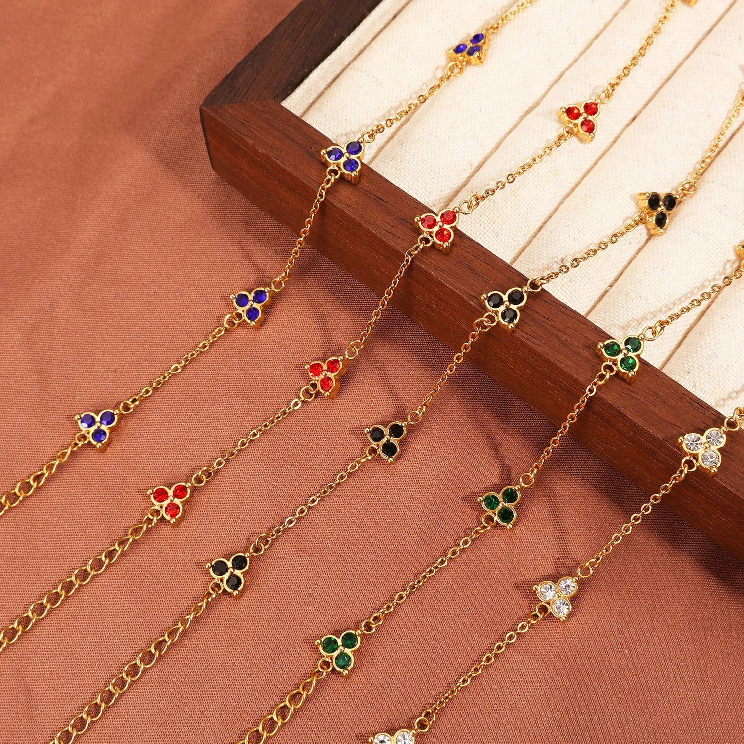 Stainless steel women's bracelet with three triangular diamond motifs set with colourful zircon stones.