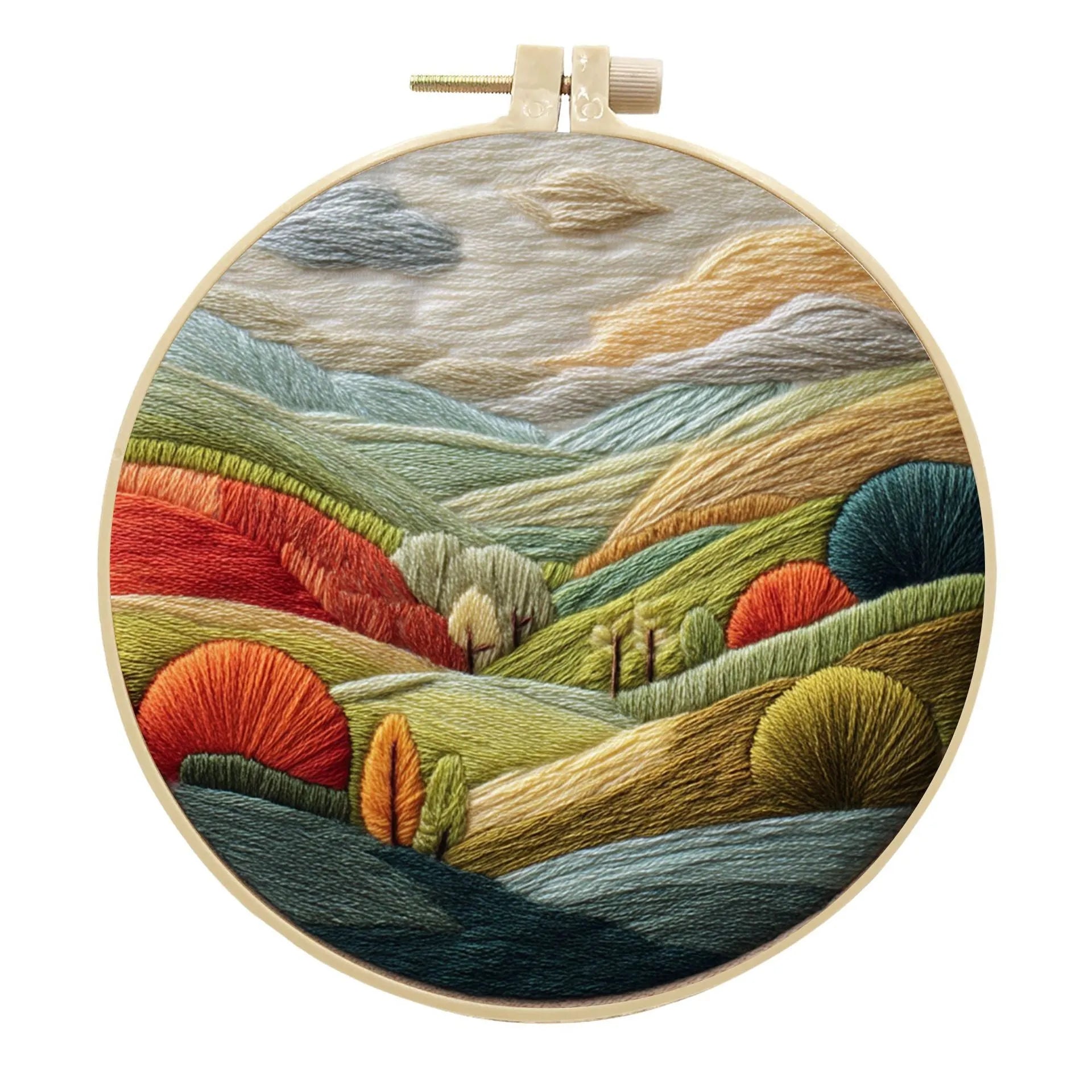 DIY landscape embroidery kit with cotton fabric, bamboo frame, threads and needles arranged for crafting