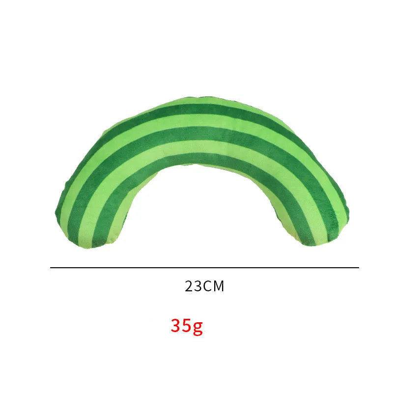 Green cat toy set containing a noise maker with catnip and a small striped pillow on a neutral background