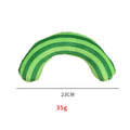 Green cat toy set containing a noise maker with catnip and a small striped pillow on a neutral background
