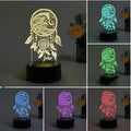 Black-based acrylic dream catcher table lamp with colourful lighting effects on a surface.