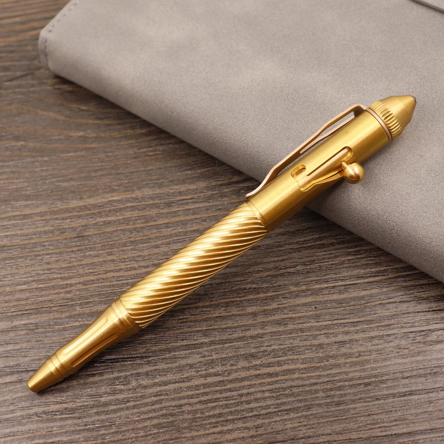 Retro brass tactical pen with press bolt-action mechanism and cylindrical metal barrel