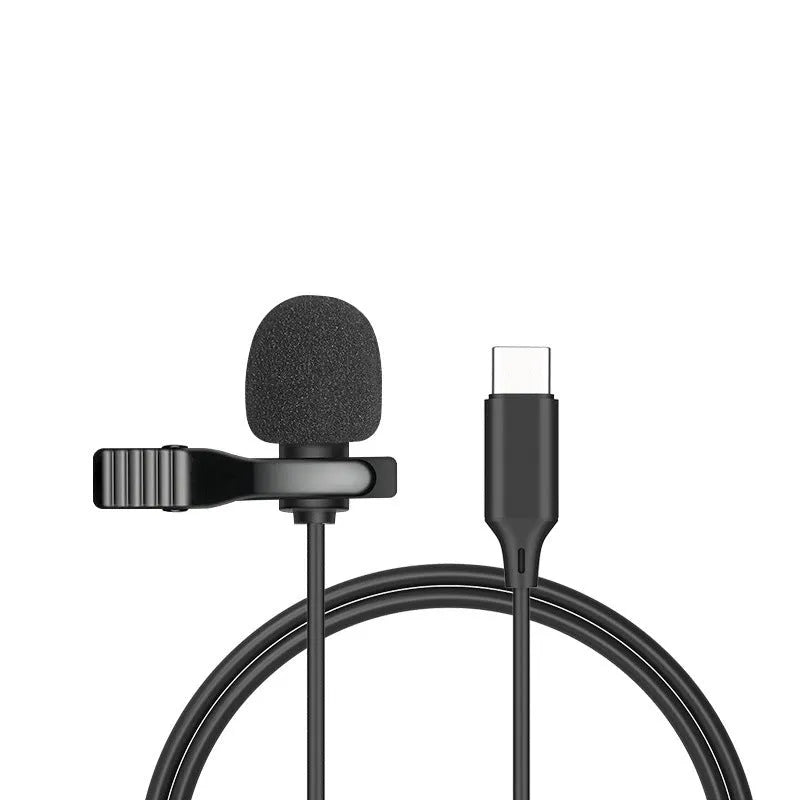 White lavalier lapel clip microphone with long cable and in-ear earpieces next to an iPhone.